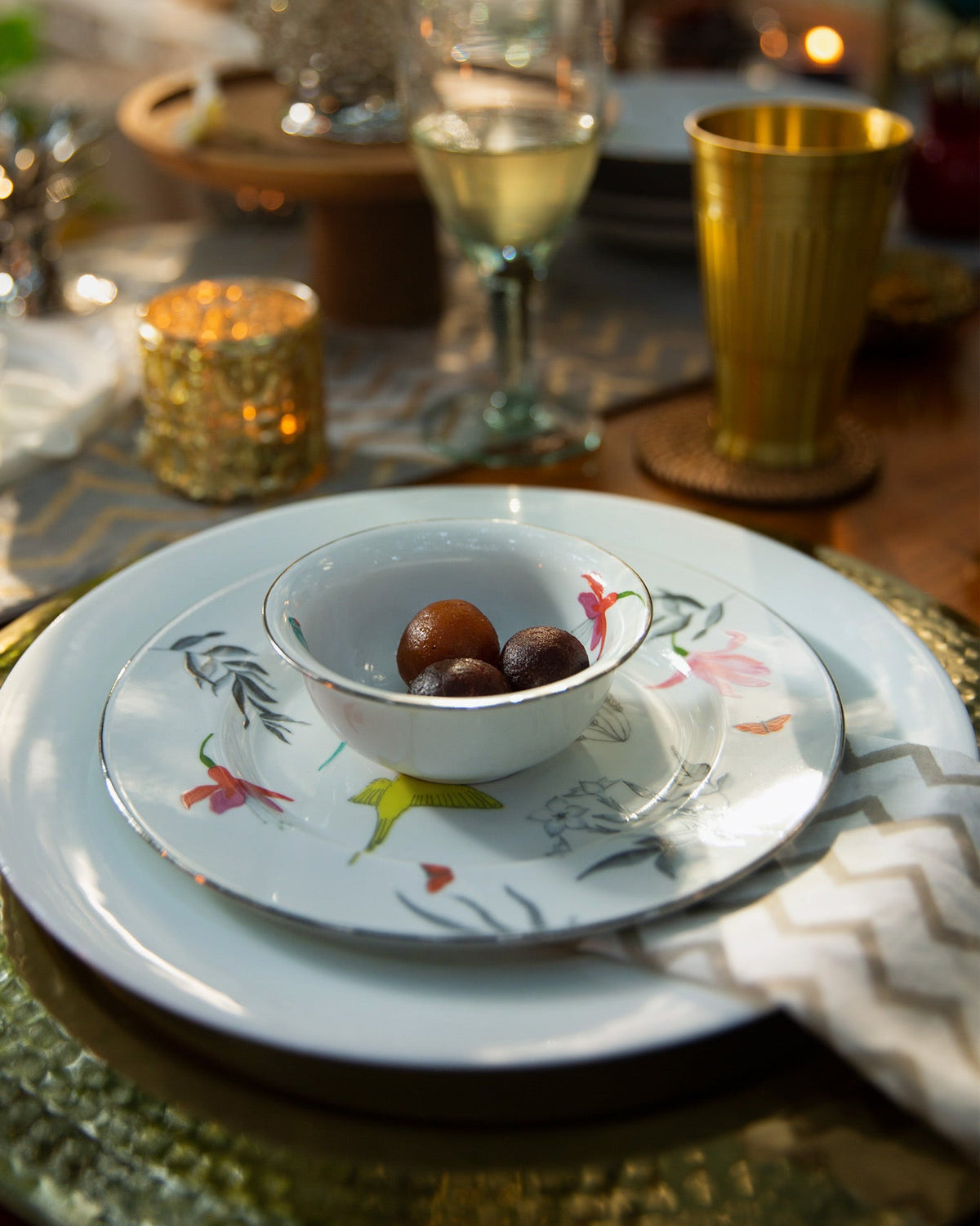 Botanical Katori holding sweets, set on a patterned plate.