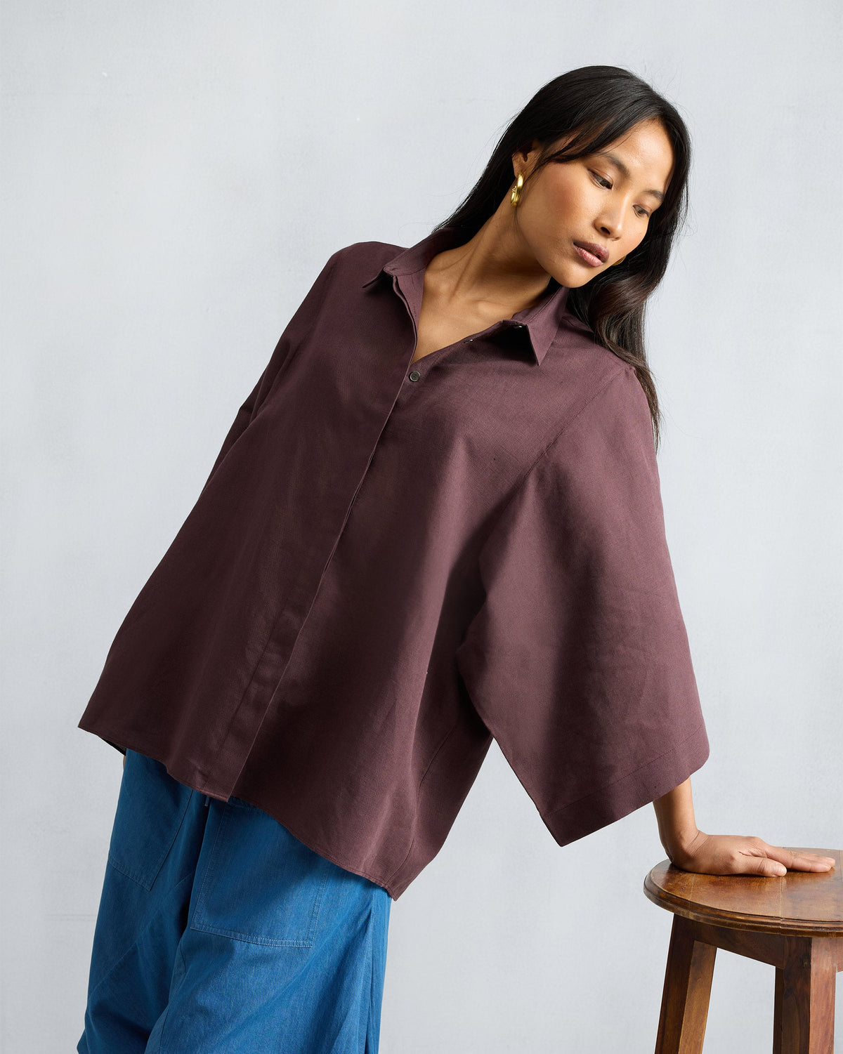 Person wearing a chocolate plum Drop Armhole Shirt with wide sleeves.