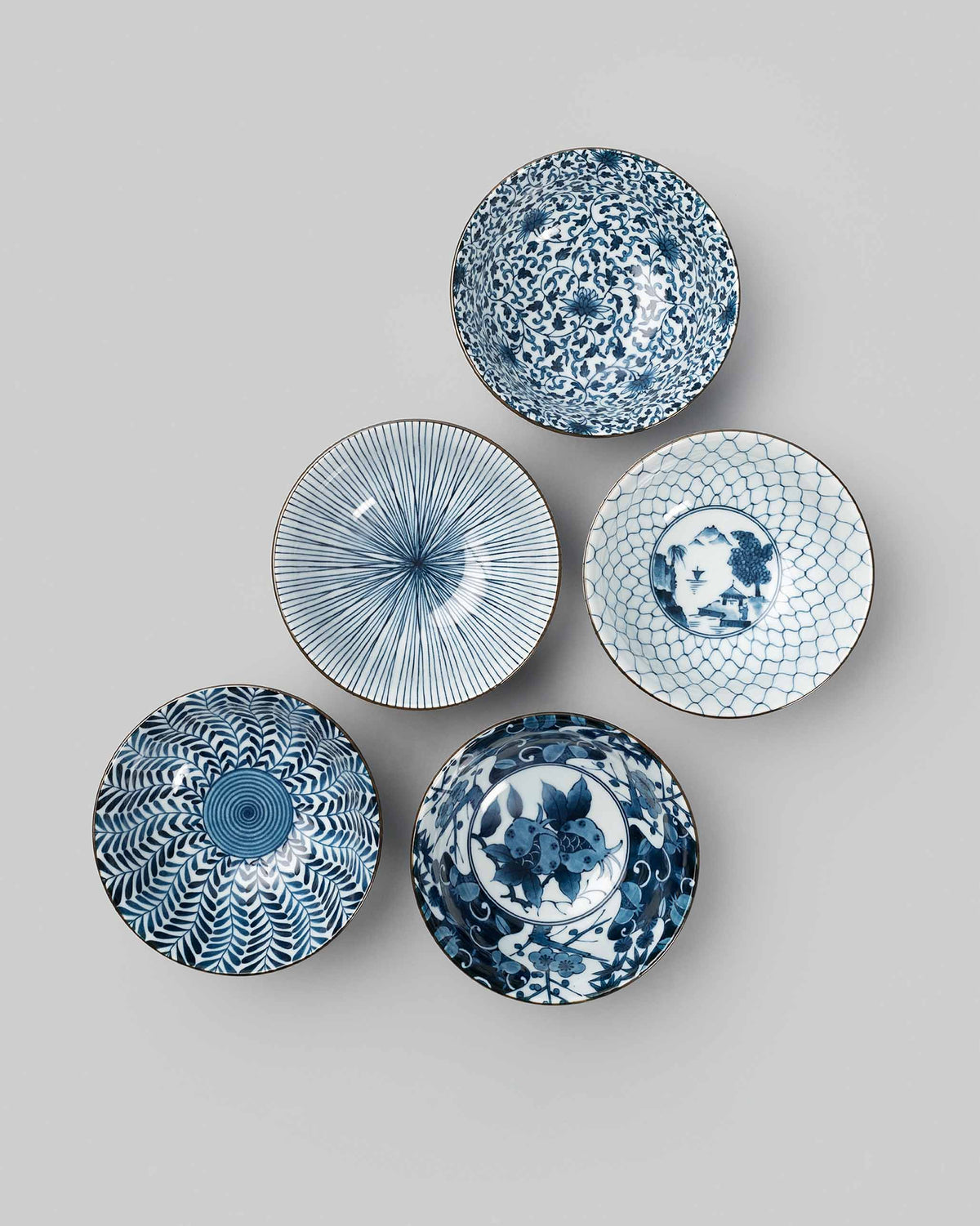 Overhead view of five Aiiro Dessert Bowl in different blue and white patterns.