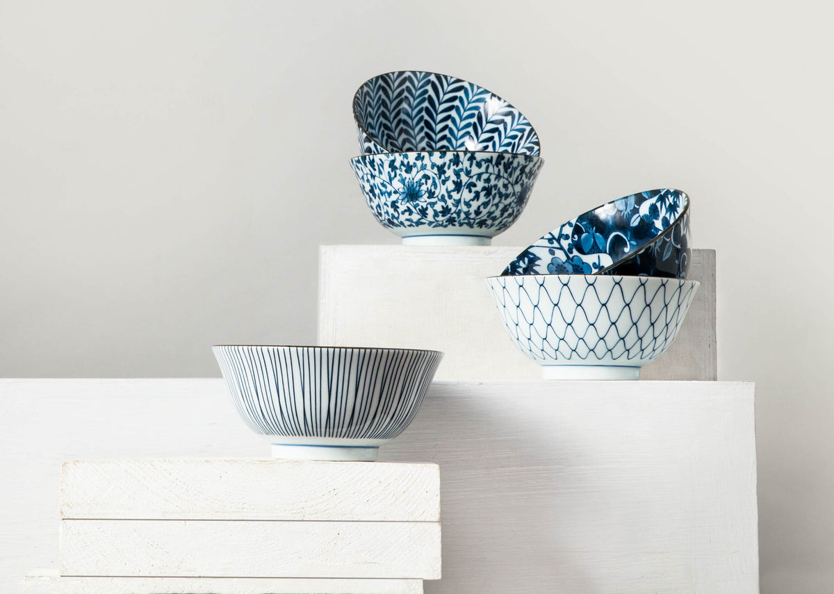 Aiiro Dessert Bowl set displayed on white blocks, with some bowls stacked.