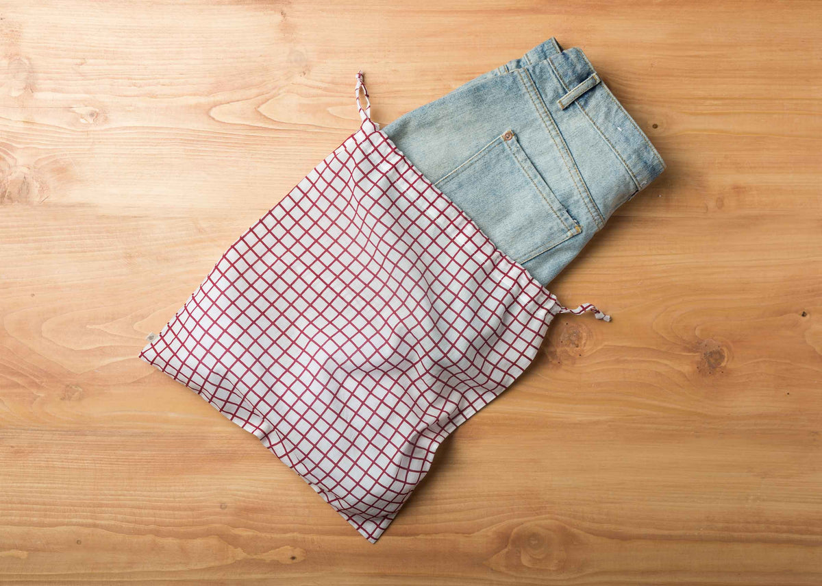 Check Wear Bag laid flat with its drawstrings open.