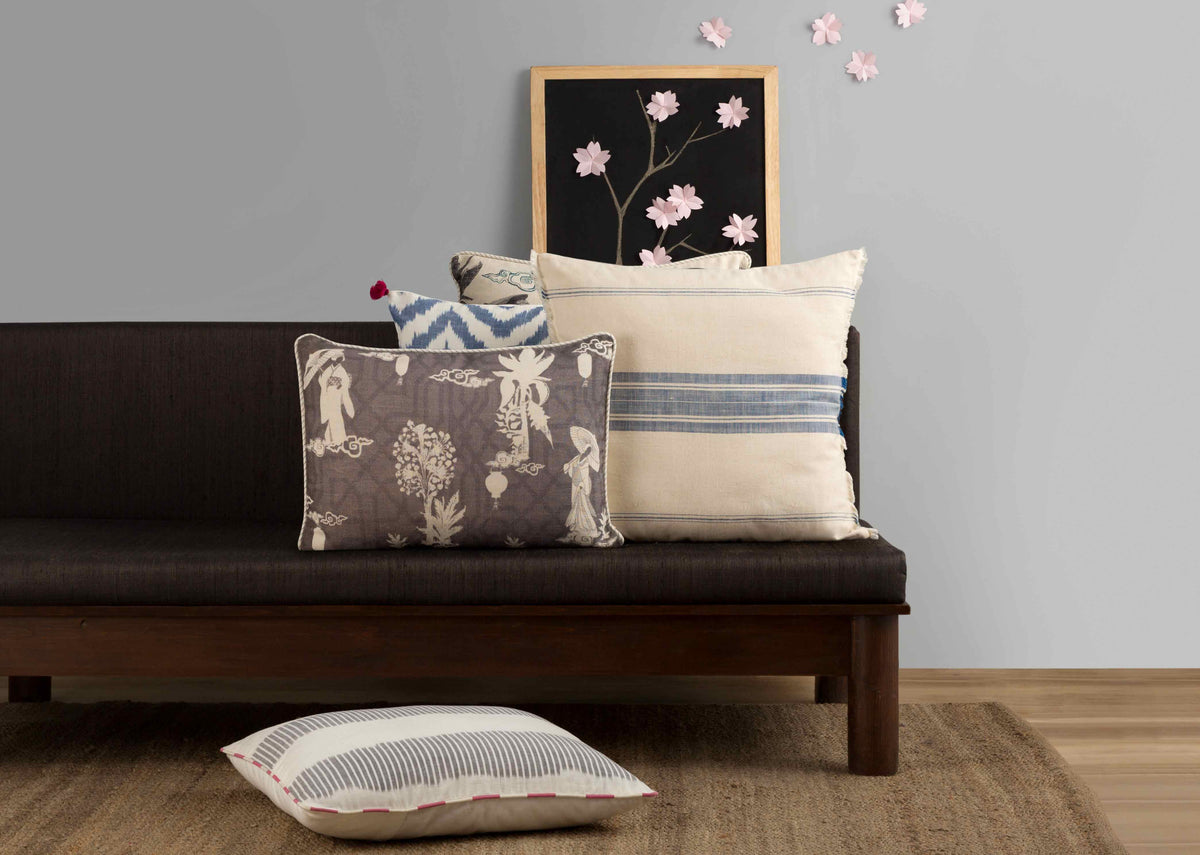 Kemuri French Stripe Cushion Cover on a sofa beside other cushions.