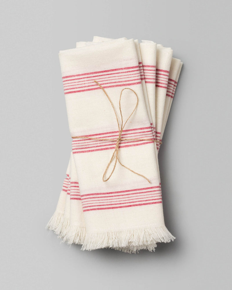 Shima Dinner Napkins in ivory with red stripes, tied with twine.
