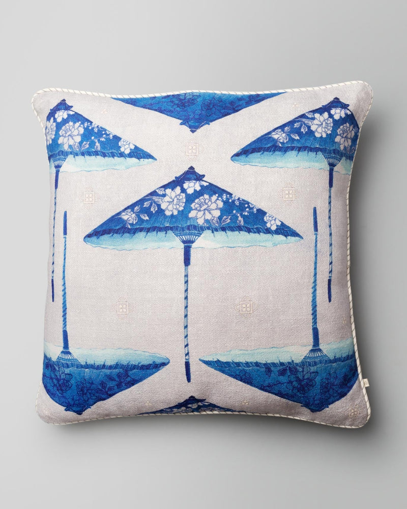 Parasol Cushion Cover with blue parasol motifs and a white piped edge.