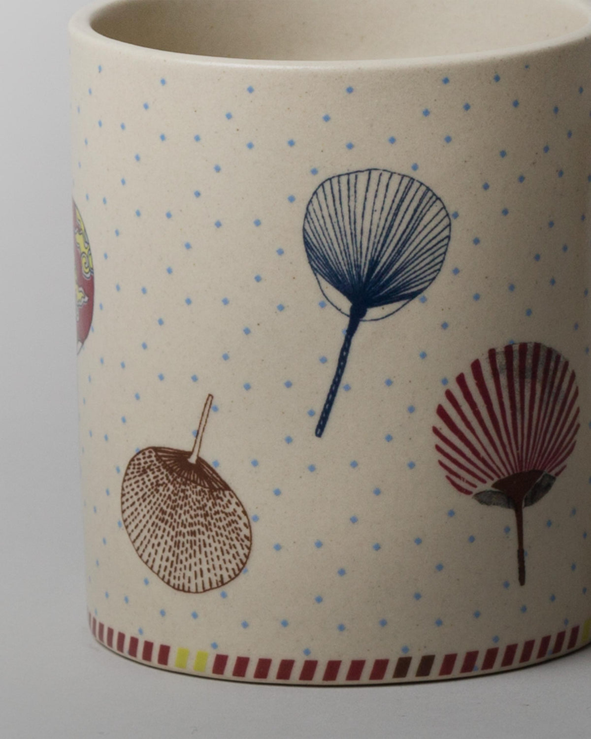 Close-up of the Kaze Wind Mug showing fan-leaf motifs and blue dots.