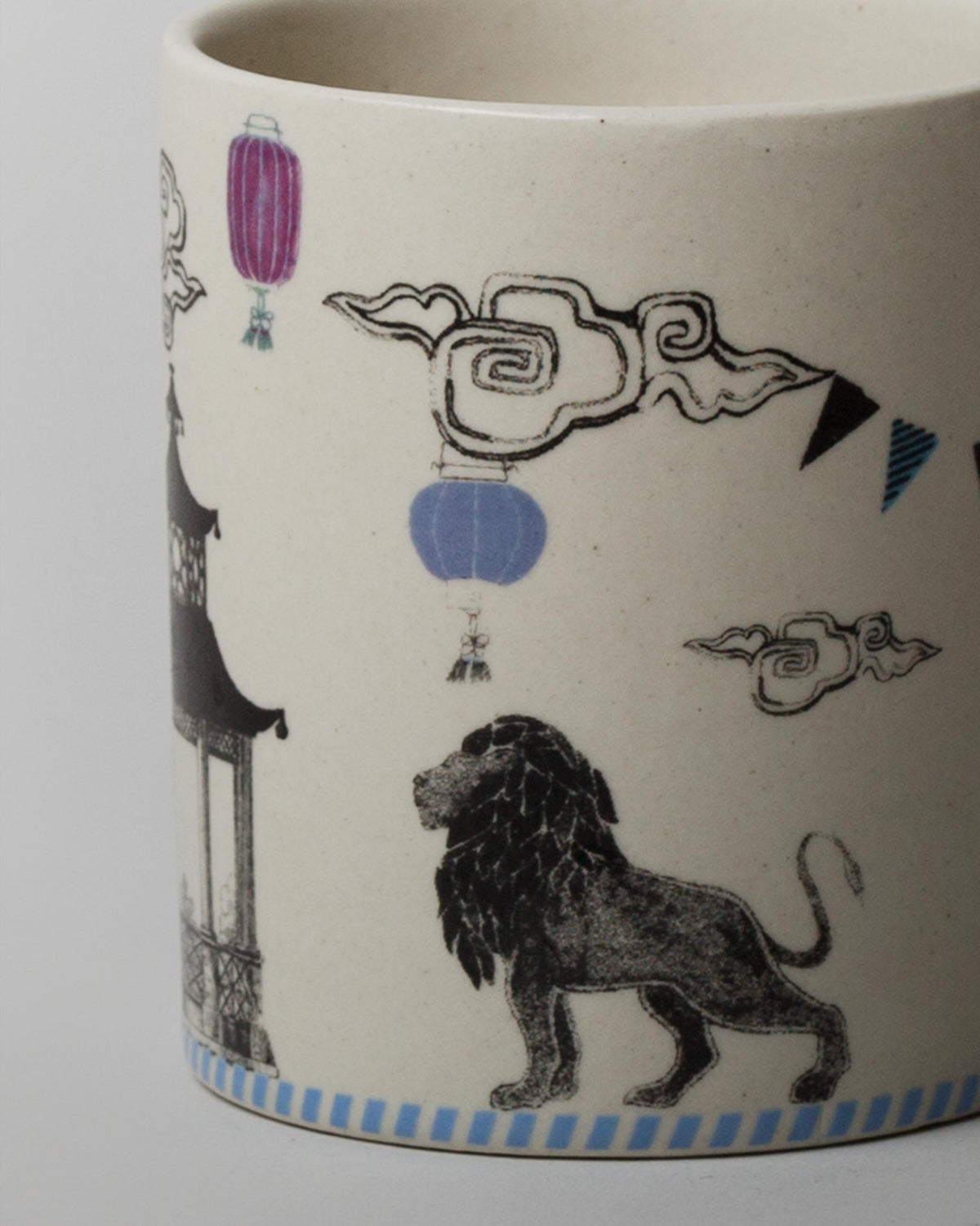 Close-up of Raion Lion Mug showing lions, lanterns and clouds.