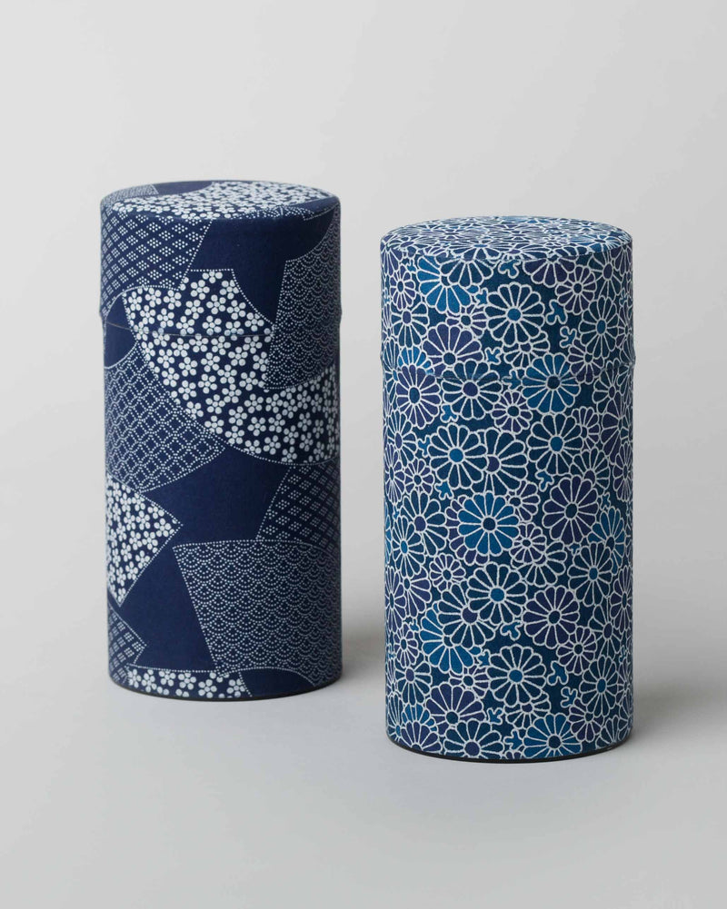 Pair of Aiiro Tea Cans, one navy patchwork and one blue floral.