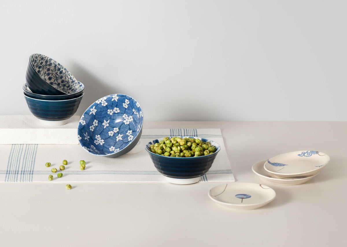 Sakura Snack Bowl among blue and white bowls on a table.