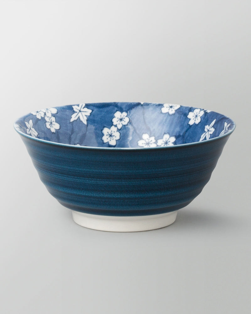 Sakura Snack Bowl with a dark blue outside and white blossoms inside.