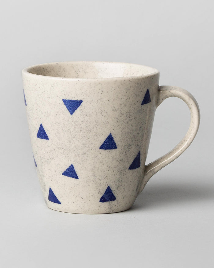 Sencha mug in white glaze with scattered blue triangles.