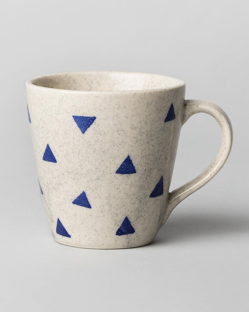 Sencha mug in white glaze with scattered blue triangles.
