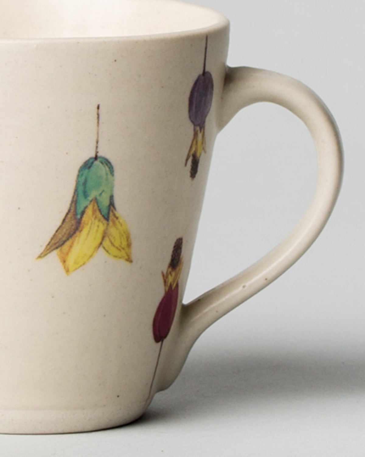 Side view of a Shunran Mug showing its handle and hanging flower motifs.