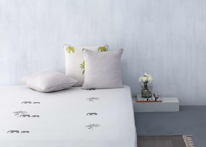Alleppey Printed King Bedcover on a bed with grey elephant and palm prints.