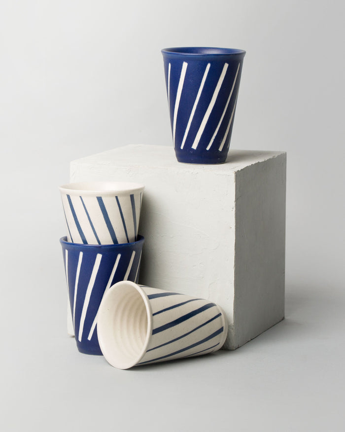 Aozora Kulhar cups with blue and white stripes, grouped together.