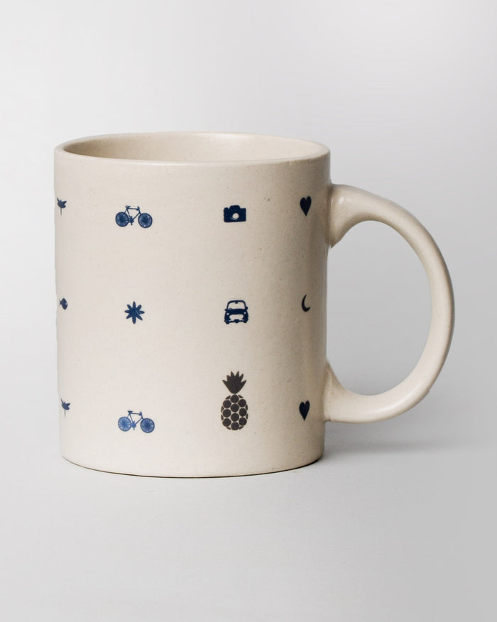Icon Mug with blue camera, car, bicycle and pineapple icons.