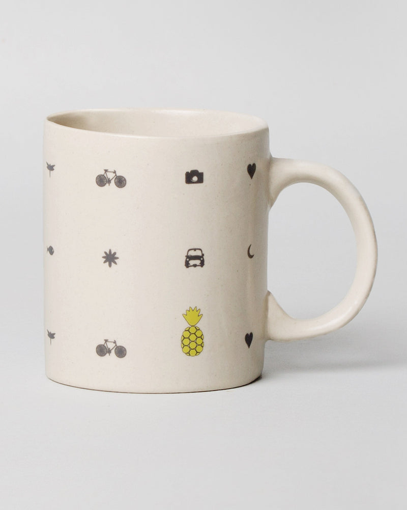 Icon Mug with charcoal camera, car and bicycle icons and a yellow pineapple.
