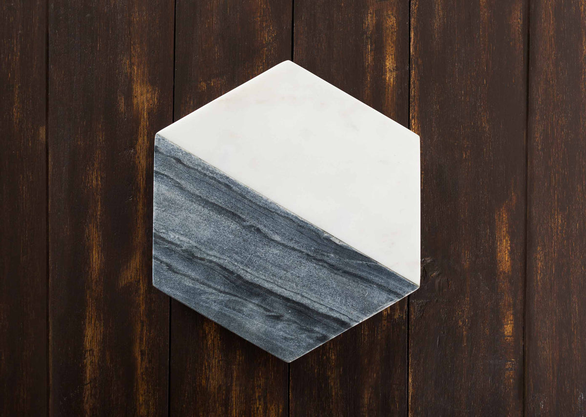 Overhead view of the Ceylon Hexagon Cheeseboard, half white and half grey marble.