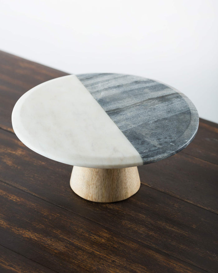 Ceylon Cake Stand with a split white and grey marble top on a wooden base.