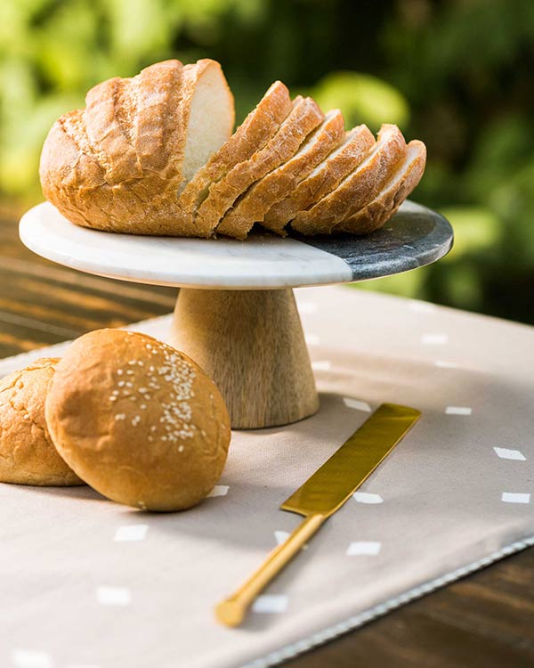 Ceylon Cake Stand holding sliced bread on a wooden pedestal.