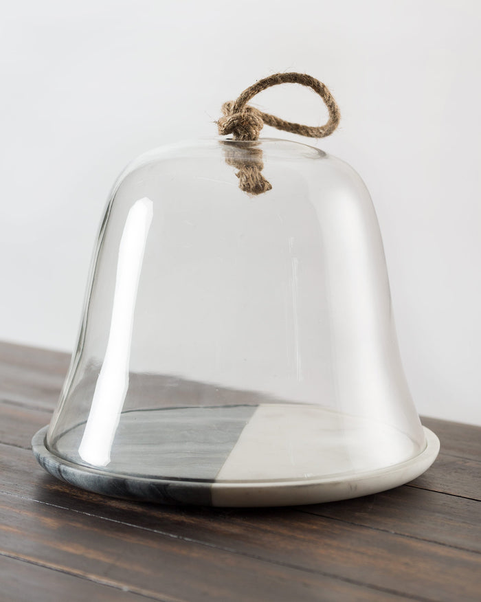 Ceylon cheese dome with a rope handle on a grey and white base.