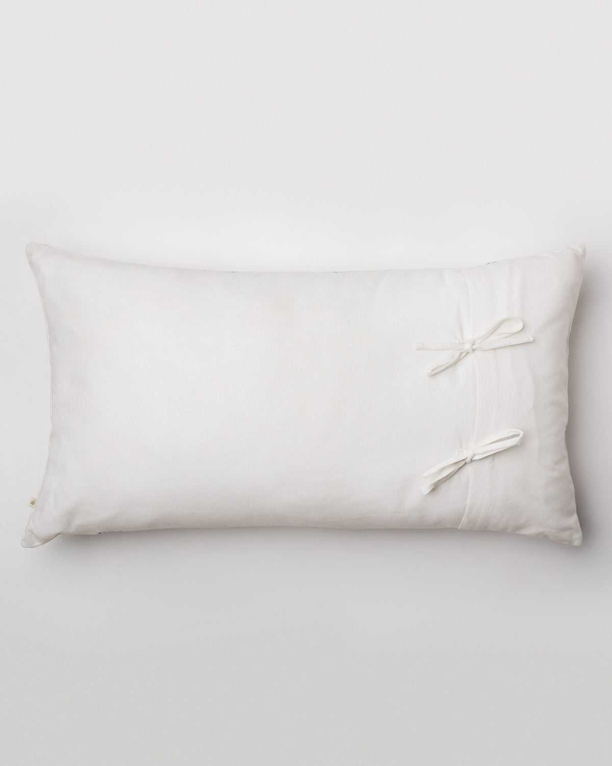 Back of the Ceylon pillow cover showing its ribbon ties.
