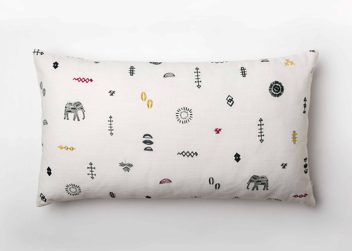 Ceylon pillow cover laid flat, with embroidered elephants among small motifs.