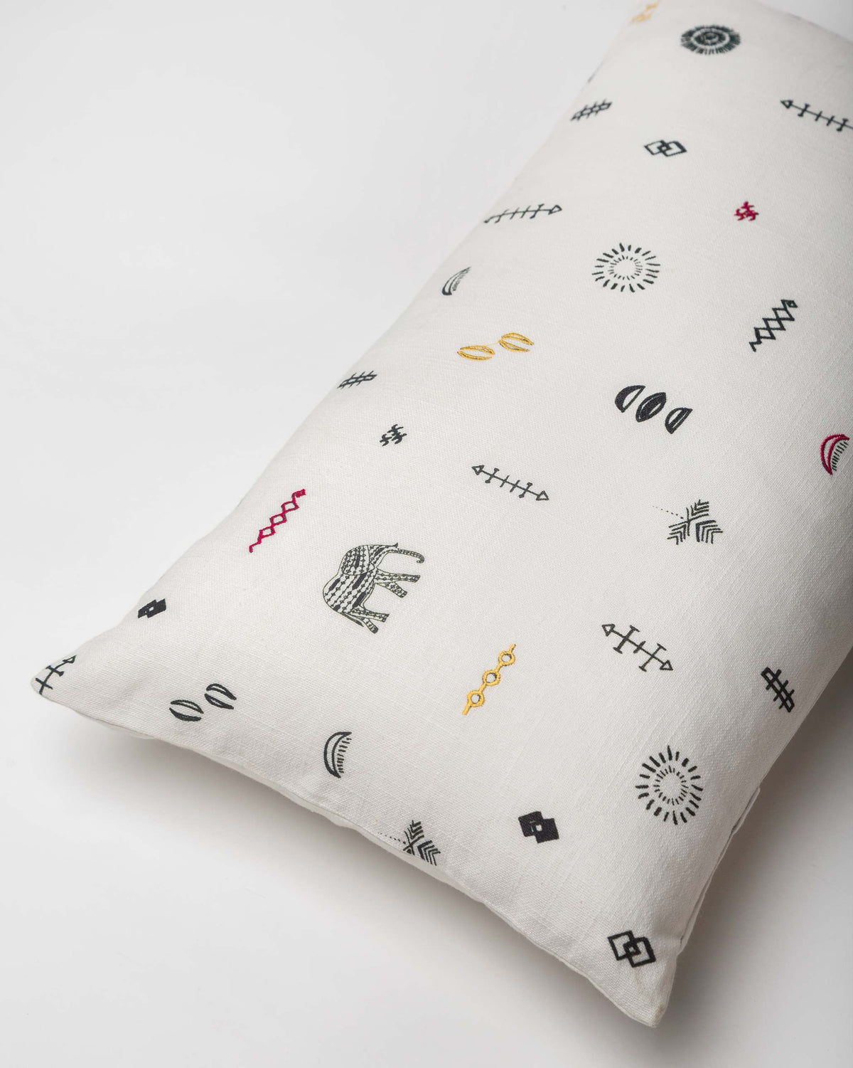 Angled view of the Ceylon pillow cover with its scattered embroidered motifs.