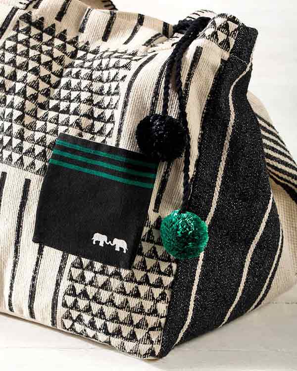 Close-up of the Coast Bag showing its pocket with a white elephant motif.