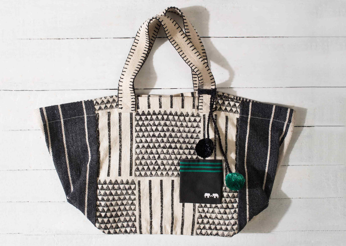 Flat view of the Coast Bag, with triangle weave and striped side panels.