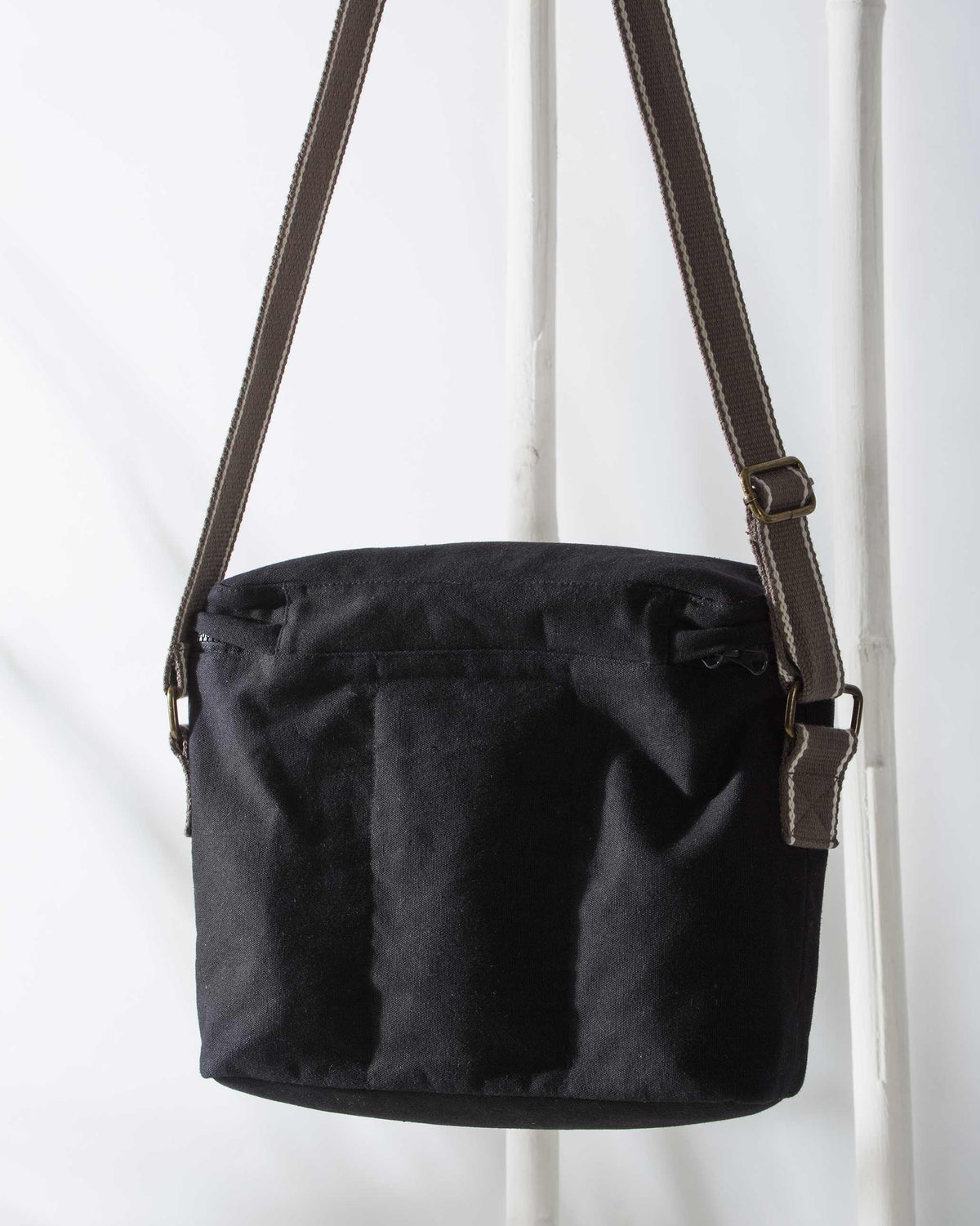Back of the Munchies & Byob Bag in black canvas, with a drawstring at the top.