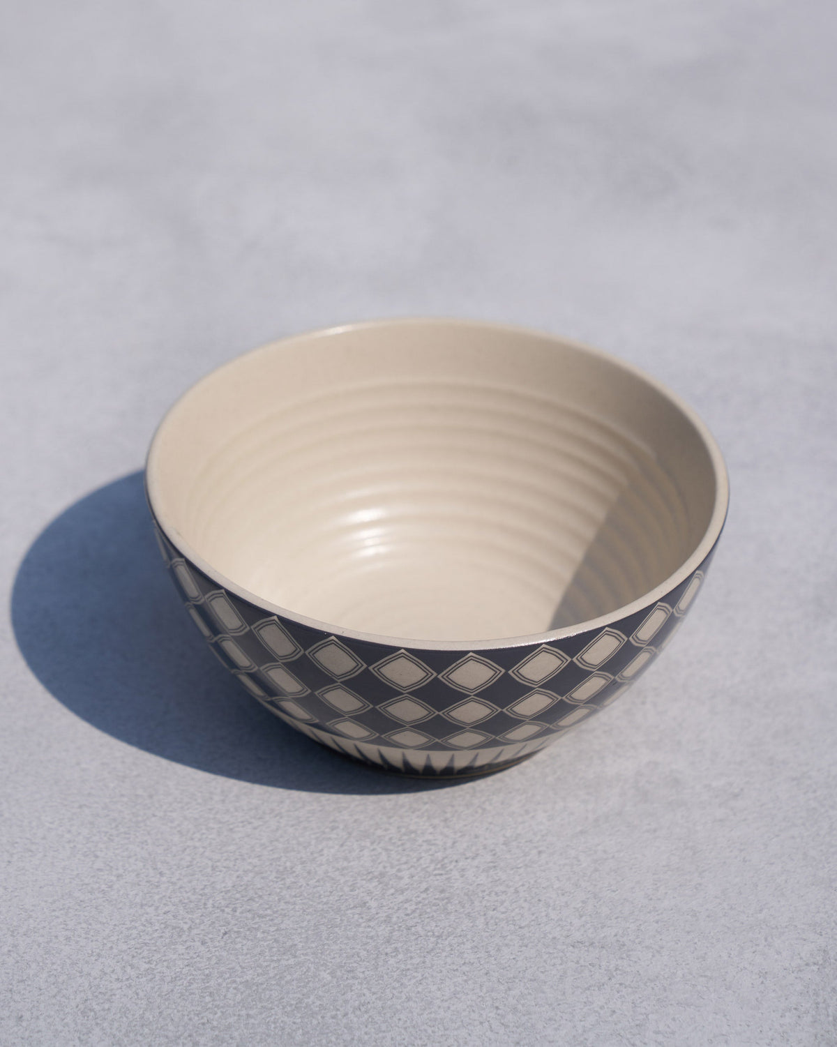 Fez cereal bowl with cream interior and a navy diamond exterior.