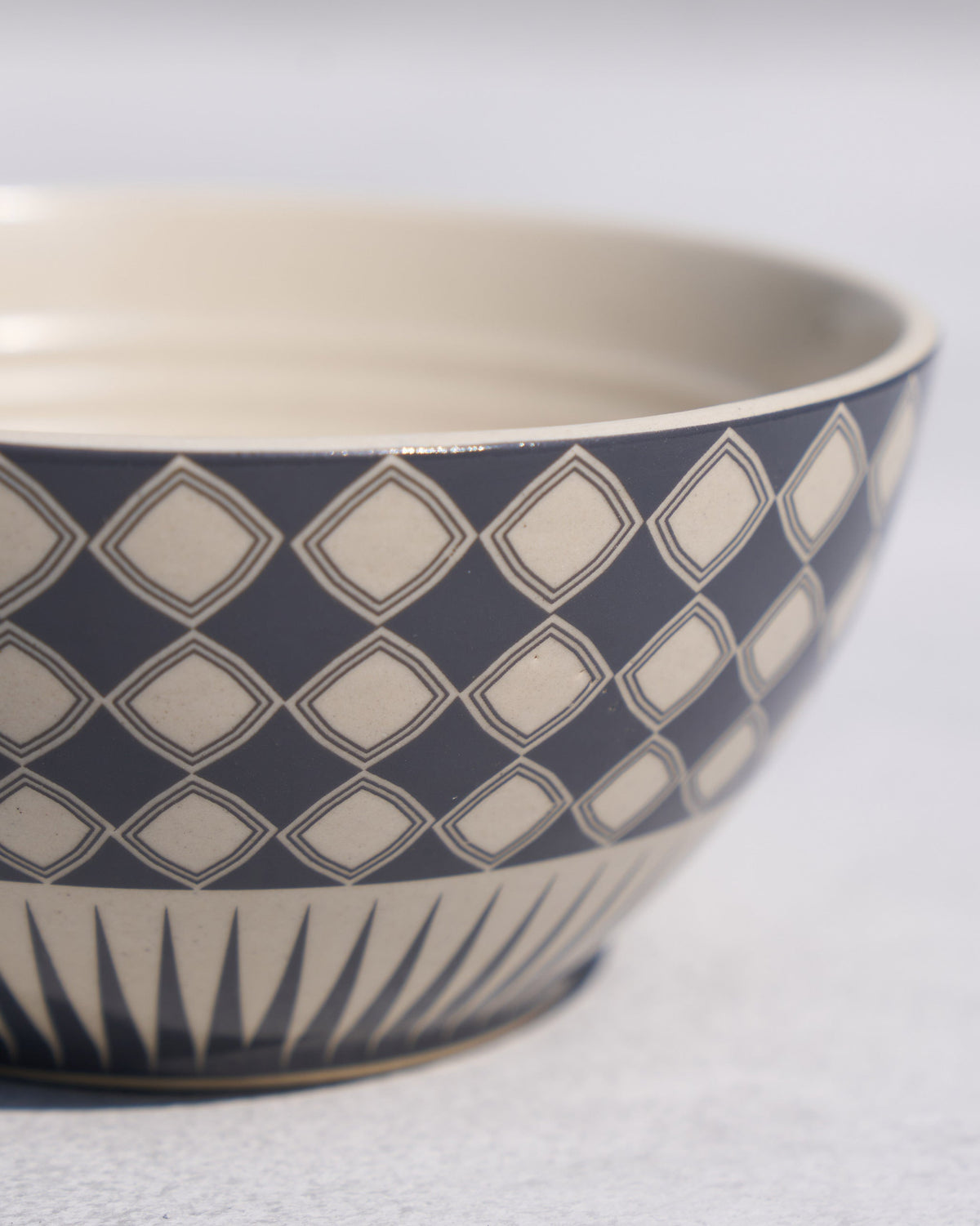 Close-up of a Fez cereal bowl showing navy diamonds and base spikes.