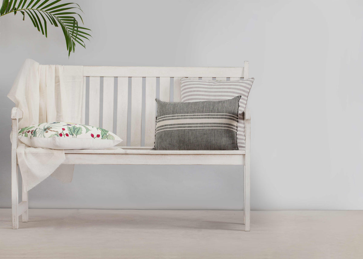Alleppey French Stripes Pillow Cover in grey, styled on a white bench.