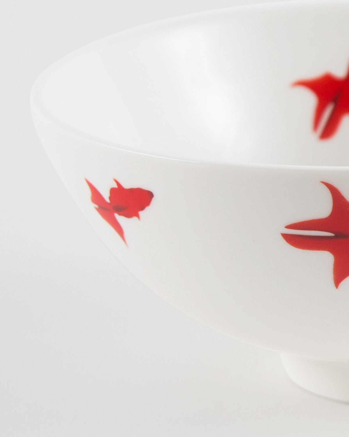 Close-up of the Guppy Shup Noodle Bowl showing red fish on its curved side.