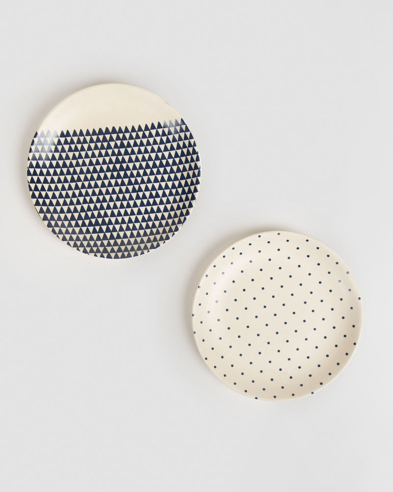 Pair of Kumarakom Cloudburst quarter plates, one with blue triangles and one with dots.