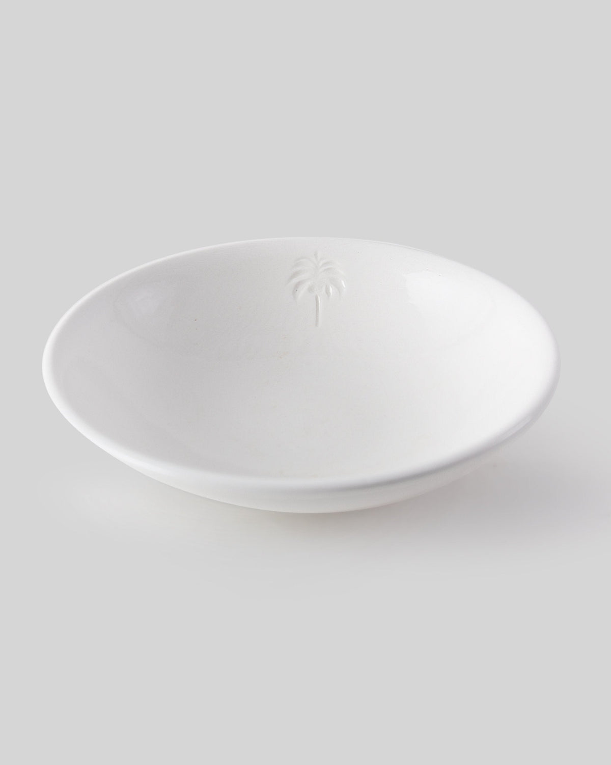 Malabar Vegetable Serving Dish at an angle, with a raised palm motif inside.