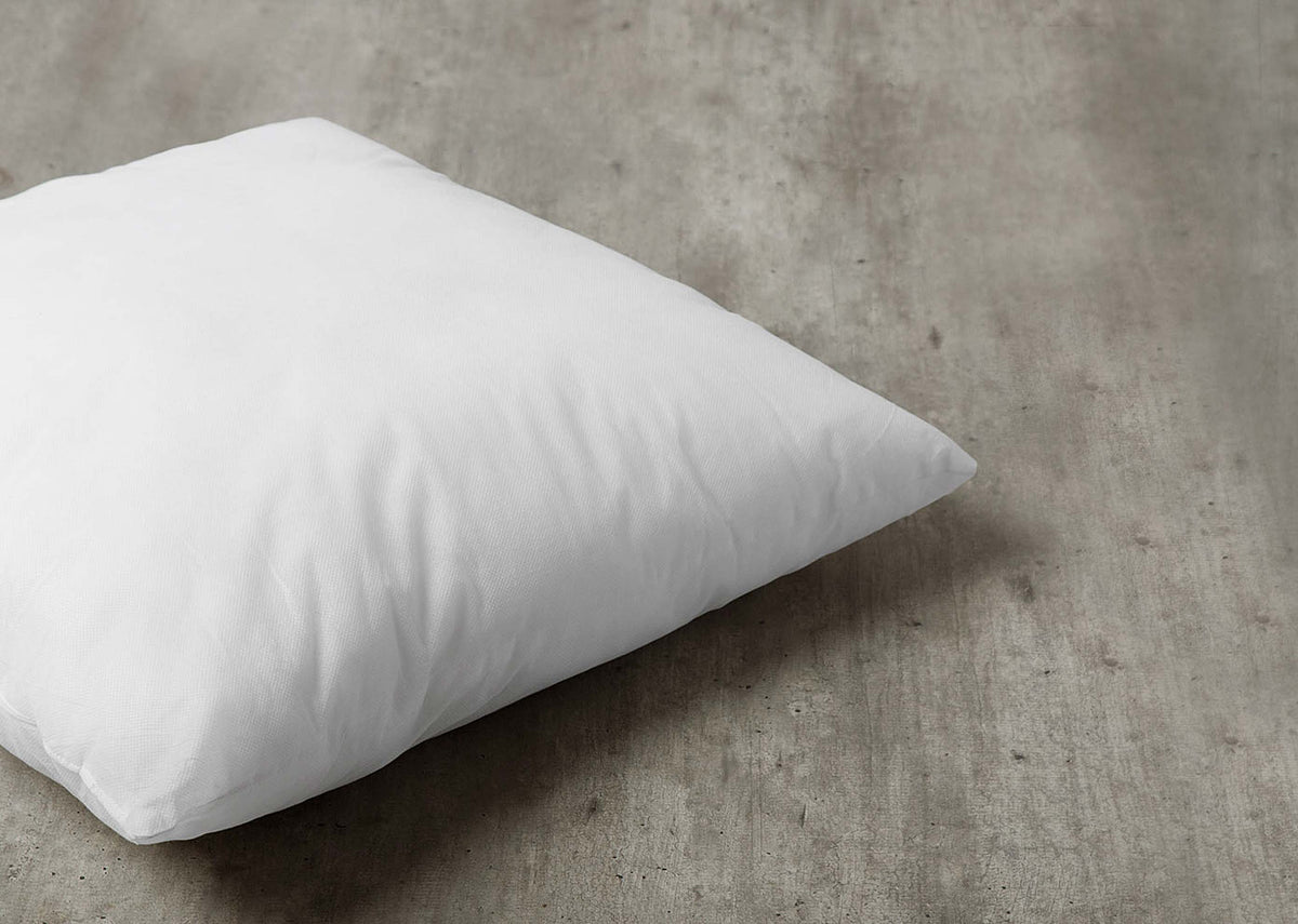 Angled view of a 46 x 46 cm cushion filler showing its full shape.