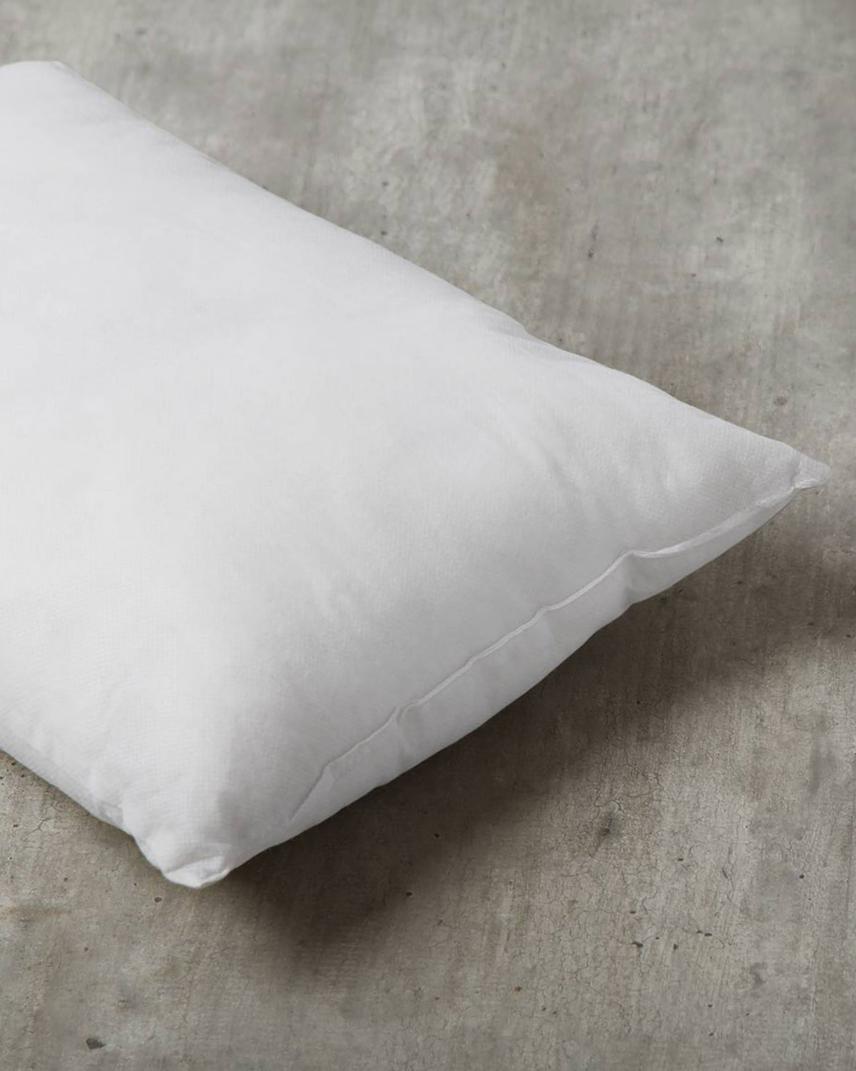 Close-up of a white Pillow Filler 36 x 51 cm showing its seamed edge.