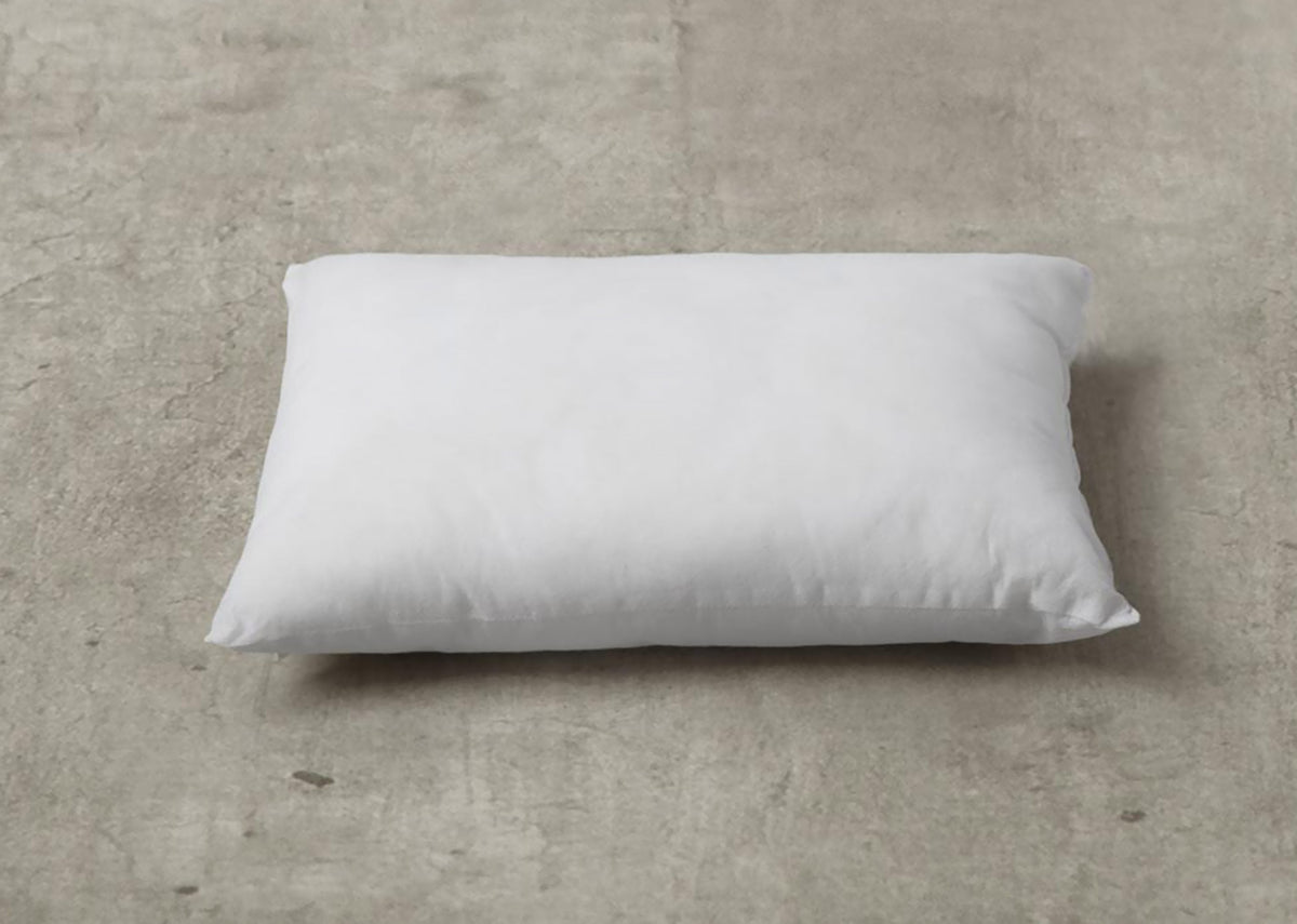 White Pillow Filler 36 x 51 cm lying flat on the floor.