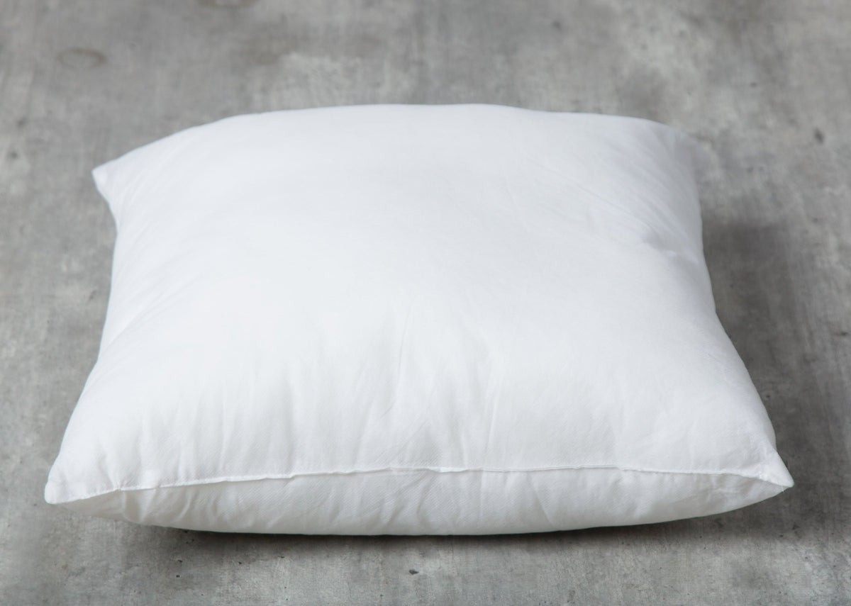 Front view of a white Sham Filler 61 x 61 cm lying flat.