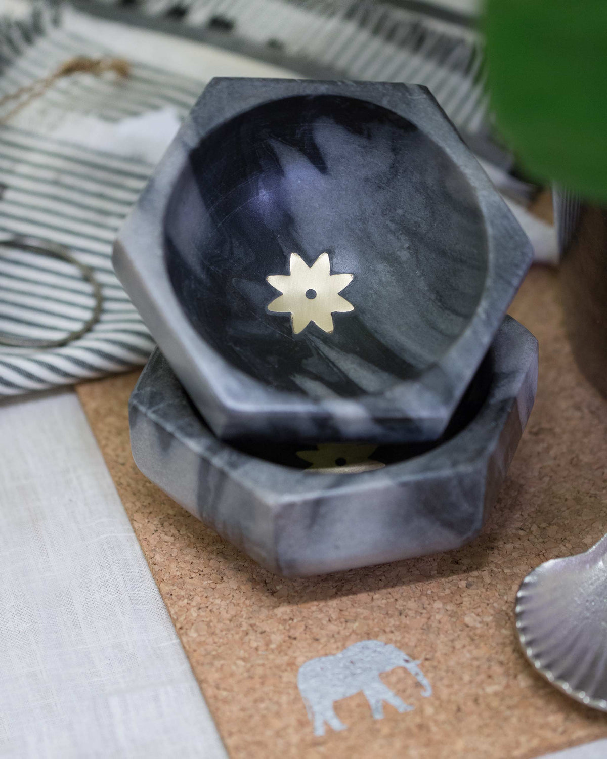 Stacked Anise marble bowls with a gold star motif inside.
