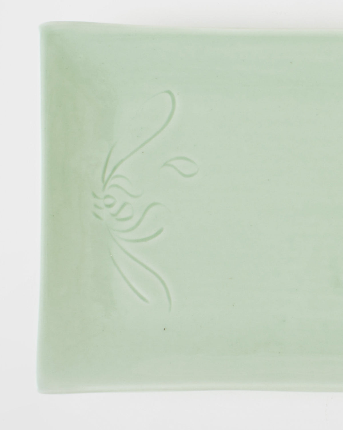 Close-up of a Celadon Sushi Platter showing its embossed leaf motif.