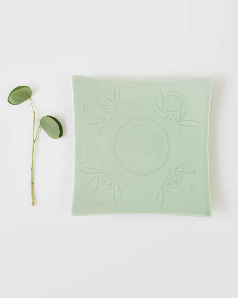 Celadon Square Plate seen from above, with embossed leaf motifs at each corner.