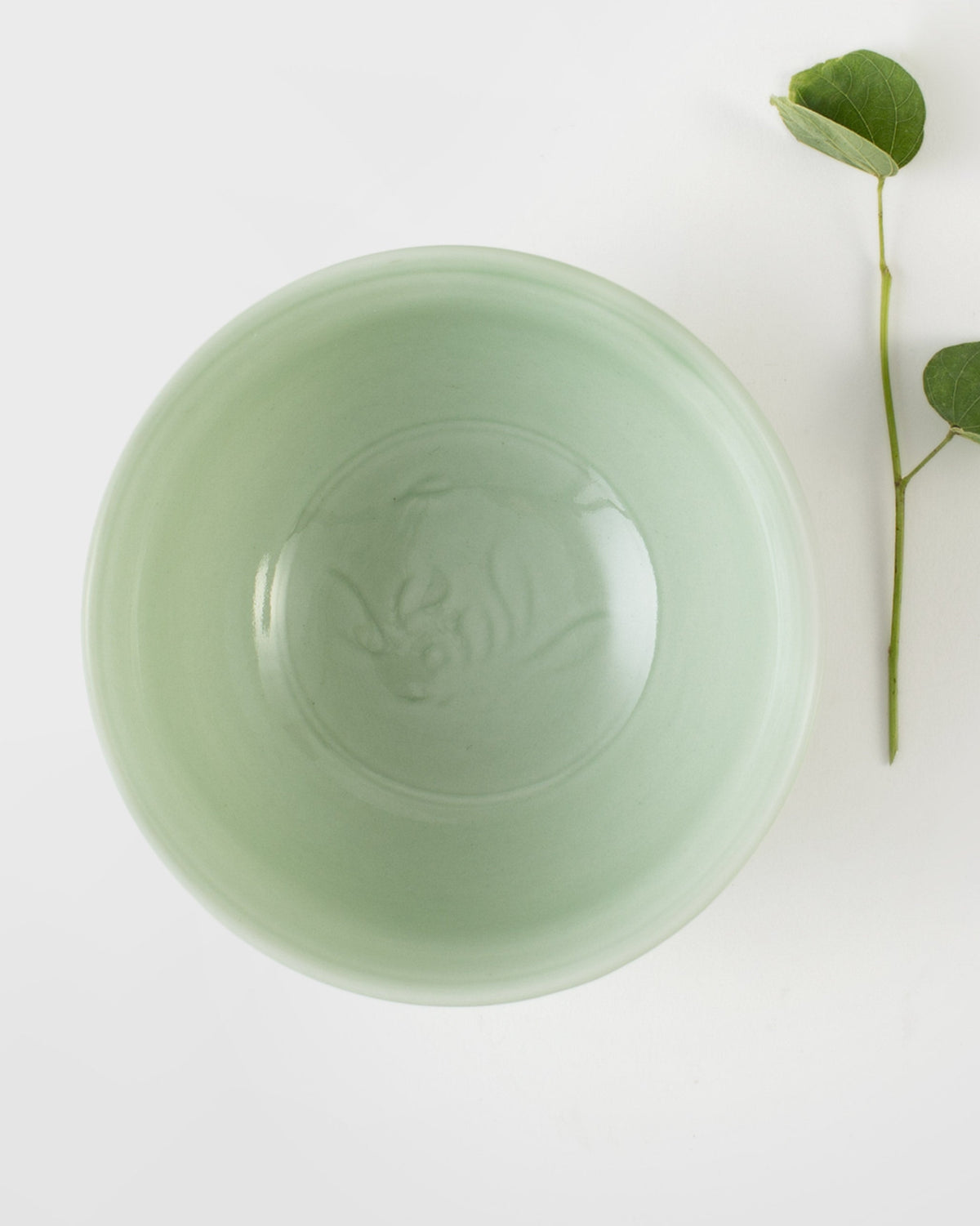 Celadon Wasabi Nut Bowl seen from above, with an embossed motif at its centre.