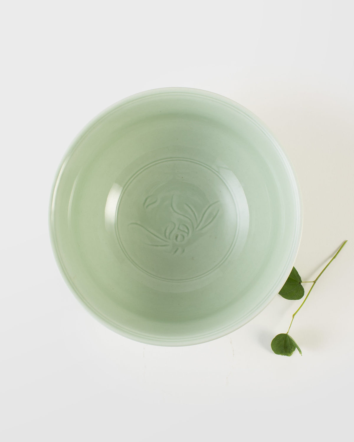 Celadon Noodle Bowl seen from above, with an embossed motif in its base.