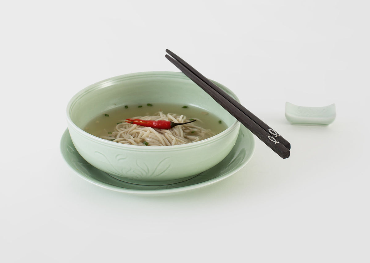 Celadon Nori Bowl filled with noodle soup on a celadon saucer, with chopsticks nearby.