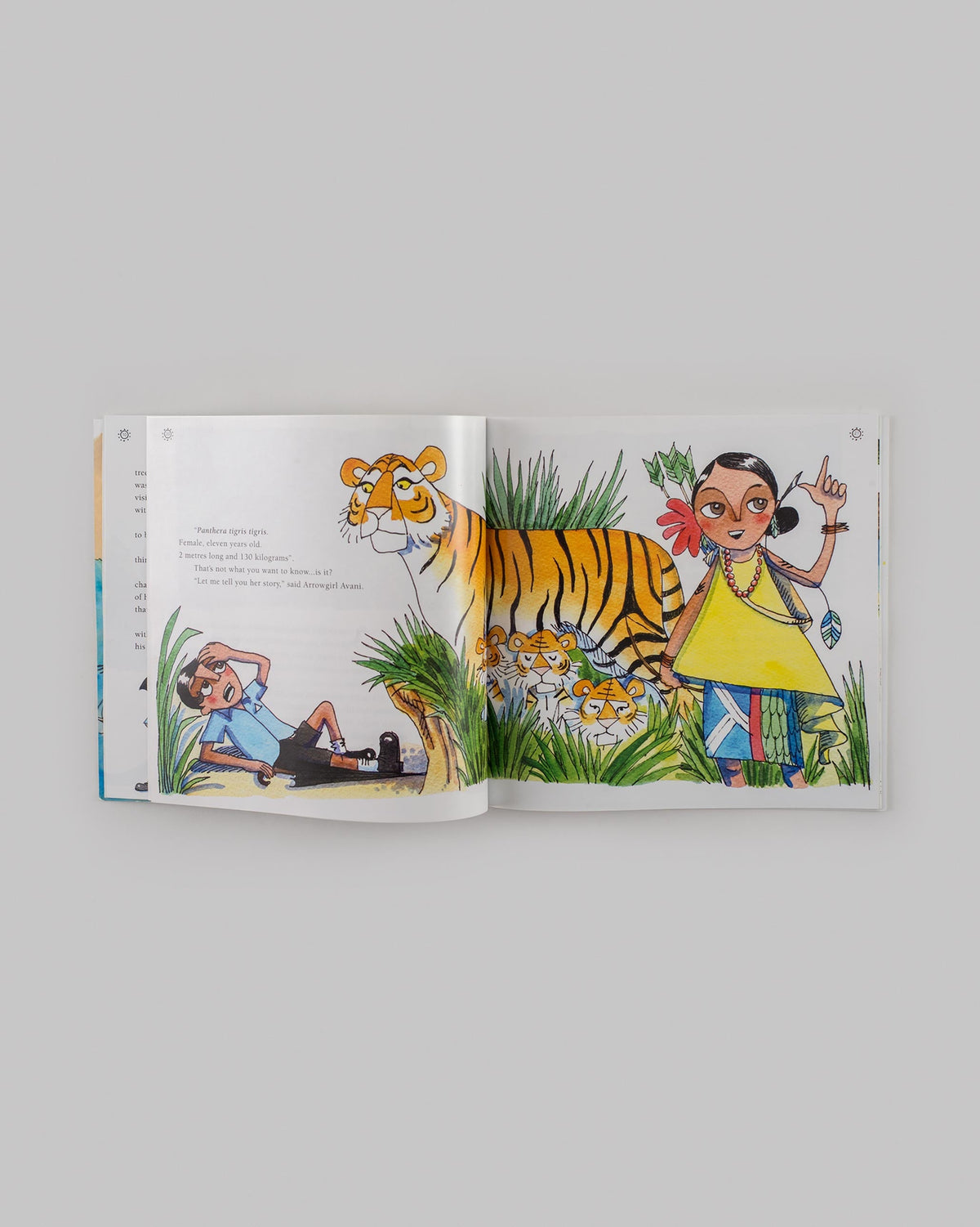 Case of The Missing Tiger Cub open to a page of tiger cubs in grass.