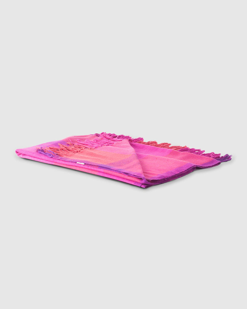 Tangier Handloom Throw in fuchsia, folded flat with fringed ends.