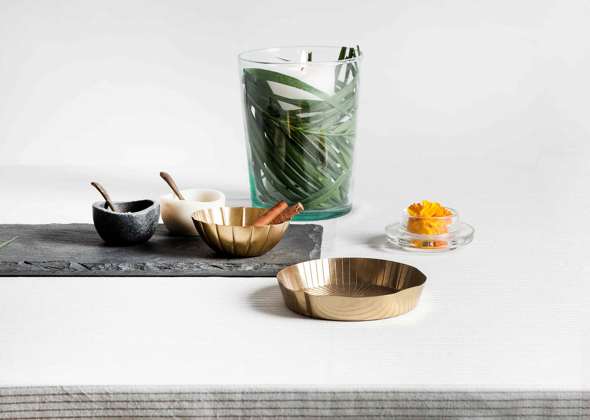 Lotus Leaf brass dessert plate with a ridged edge on a table.