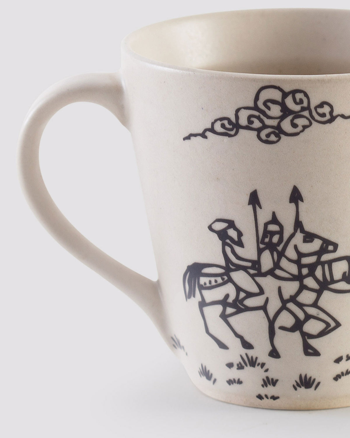 Close-up of a Pazhani Mug showing horsemen with spears and a cloud motif.